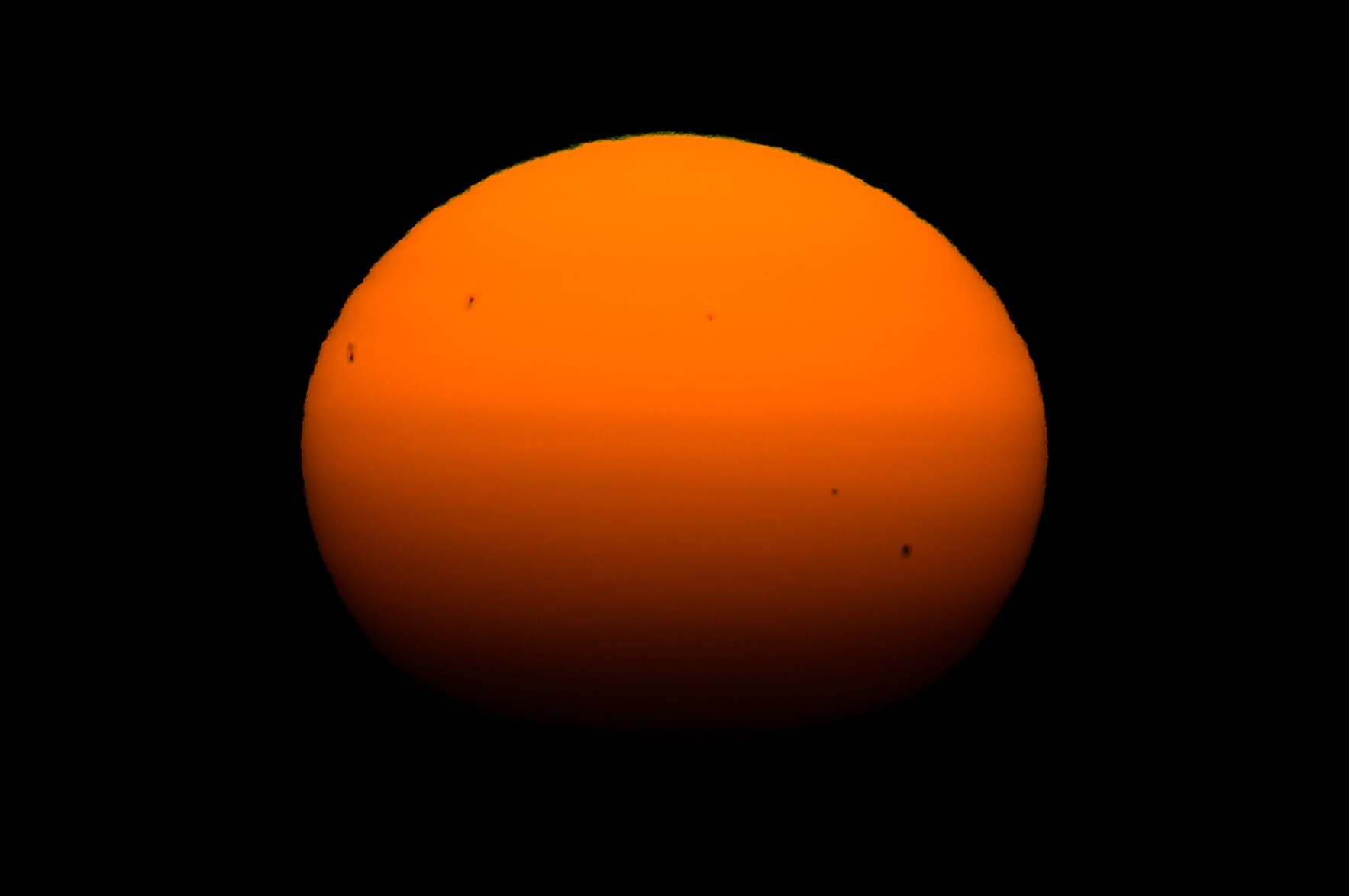 A close up picture of the setting sun showing sun spots