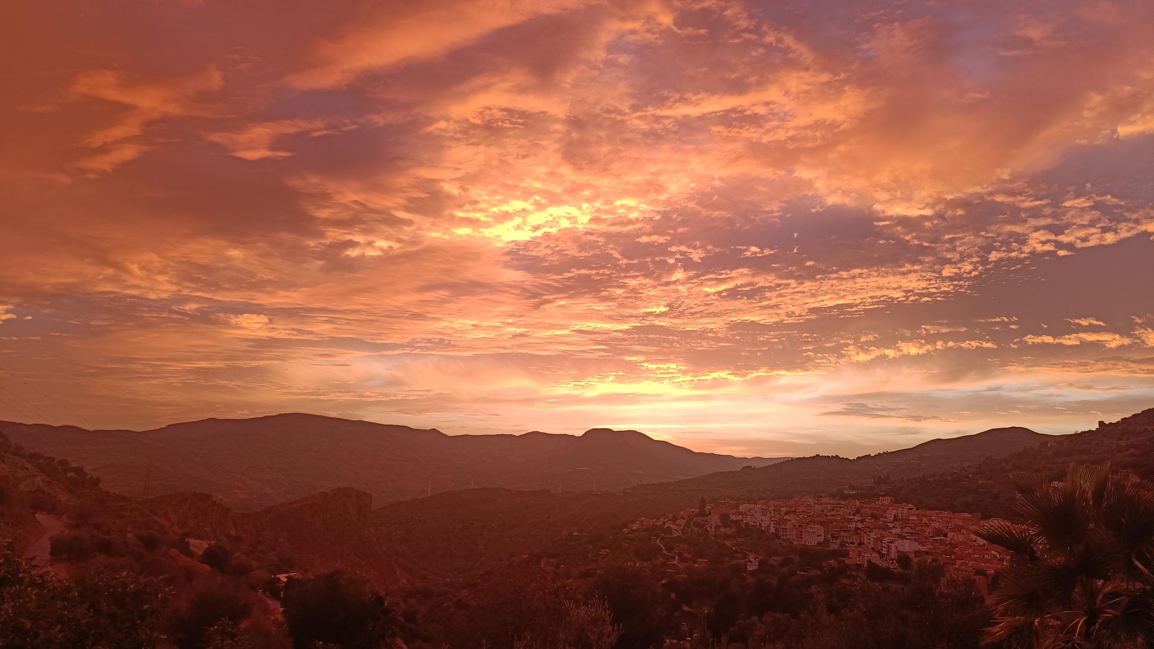 Sunset over a Spanish village. Orange colour to the sky and orange hue to the picture